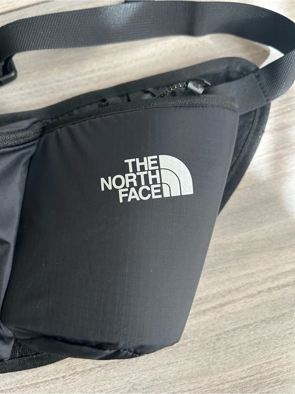 The North Face Black Sling Belt Bag with White Logo